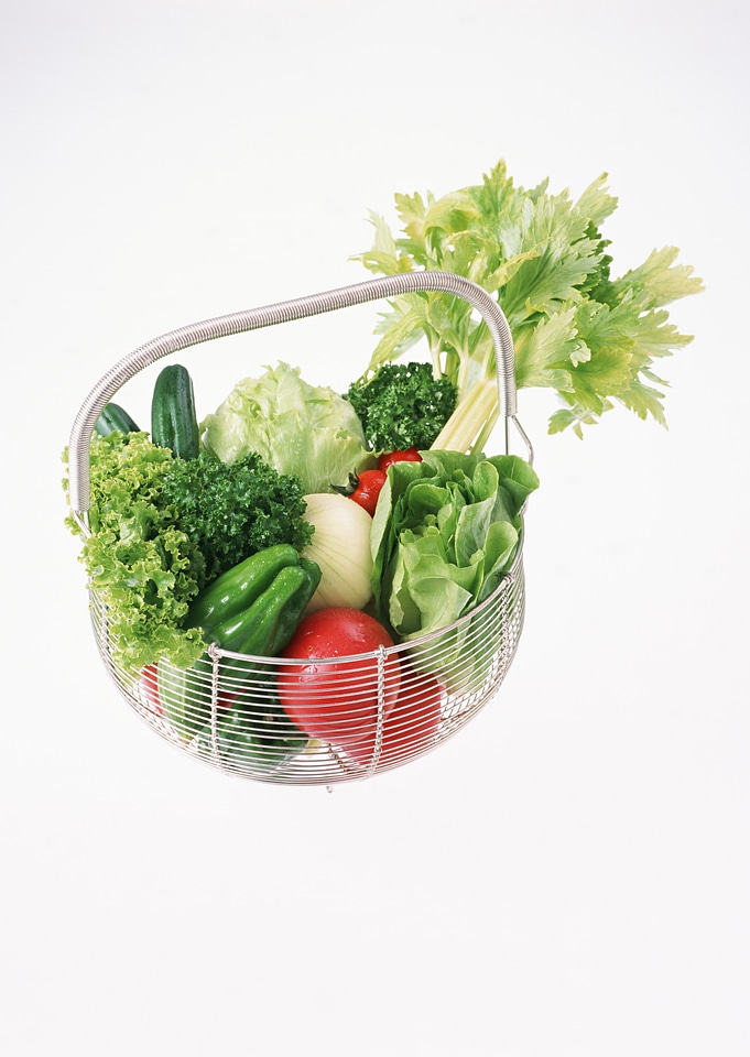 Wire shopping basket full of fresh fruit and vegetable