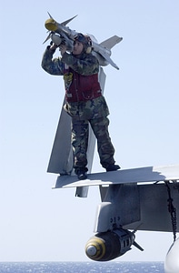 An Aviation Ordnanceman disarms an AIM-9 Sidewinder missile photo