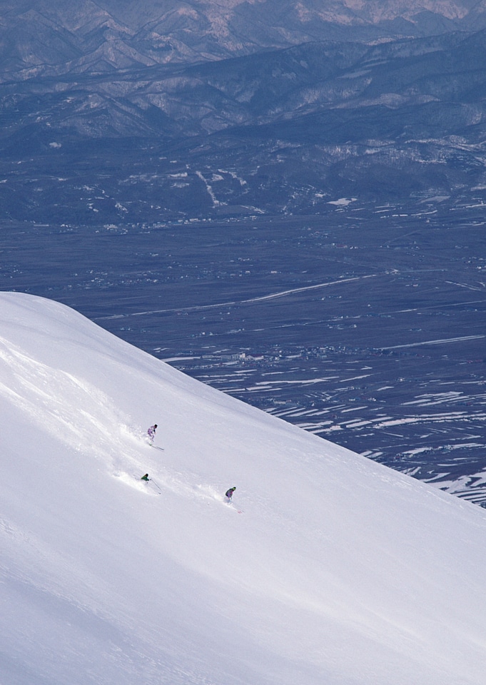 Full length of skier skiing on fresh powder snow