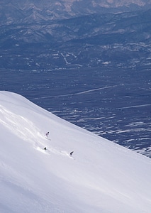 Full length of skier skiing on fresh powder snow