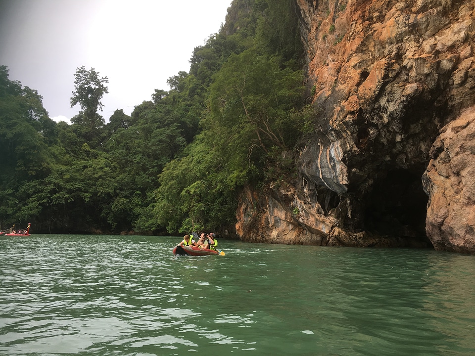 Tourists kayaking through limestone cliffs in Phang-nga Bay