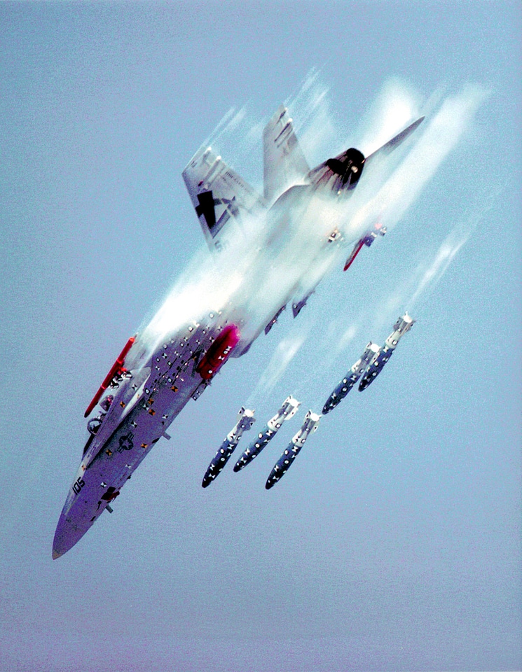 An F/A-18 Hornet releases MK-83 1000 pound bombs