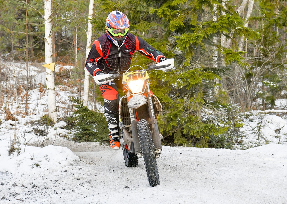 Motorcycle rider extreme sport biker on top of winter