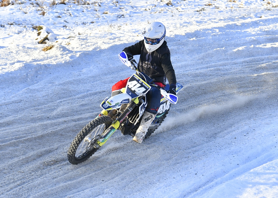 Motorcycle rider extreme sport biker on top of winter