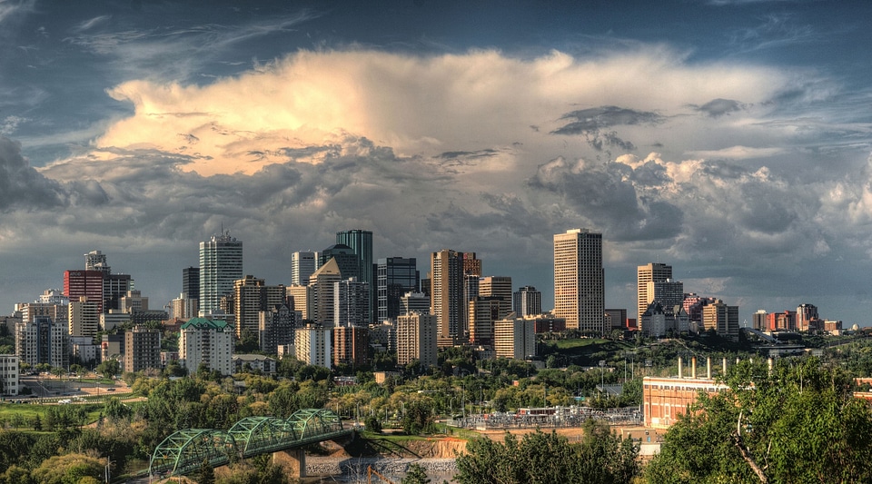 Toronto skyline over park with urban buildings and blue sky