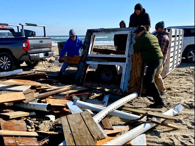 Volunteers and Superintendent Hallac unload debris from trailer 02-14-2022