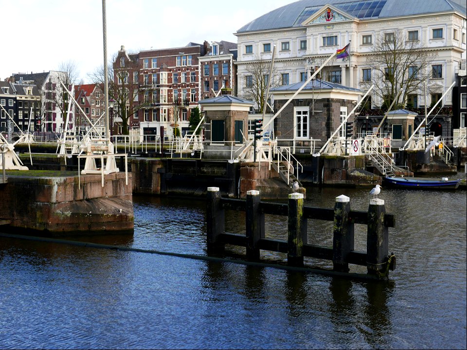 Old water locks in the river Amstel, in the old city Amsterdam; free urban photo by Fons Heijnsbroek, 2022.