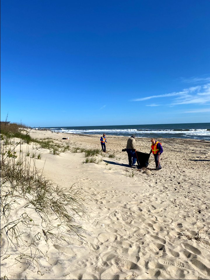 Volunteers participate in beach debris cleanup photo