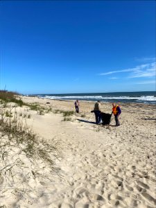 Volunteers participate in beach debris cleanup photo