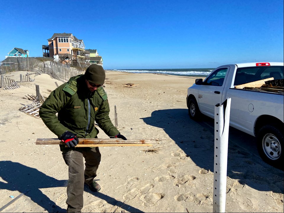 National Park Service employees collect house collapse debris