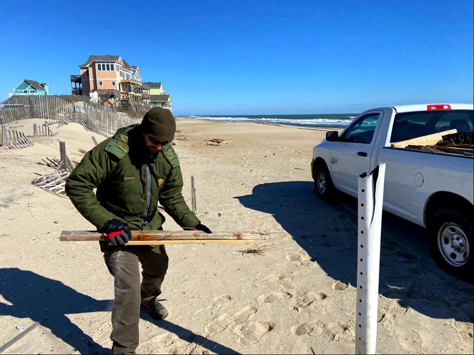 National Park Service employees collect house collapse debris photo