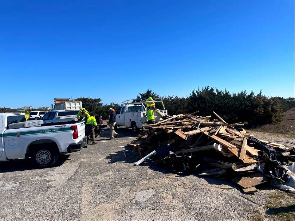 National Park Service employees transfer debris from truck to debris staging pile at Ramp 23. photo