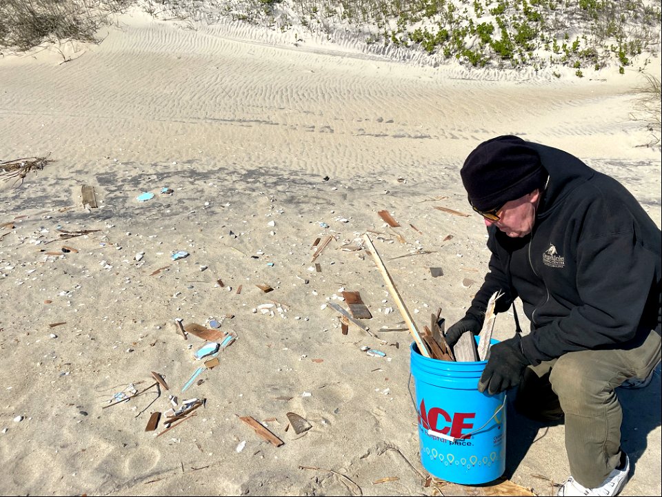 Volunteers participate in beach debris cleanup photo