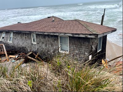 Photo of March 13, 2023, collapsed house at 23228 East Point Dr.. Rodanthe