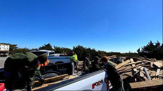 National Park Service employees work to transfer debris to staging piles