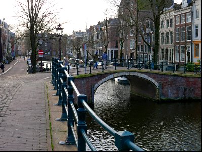 Old brick bridges over and near the canal water of the Prinsengracht; free photo Amsterdam city photo