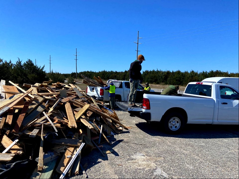 National Park Service employees work to transfer debris to staging piles