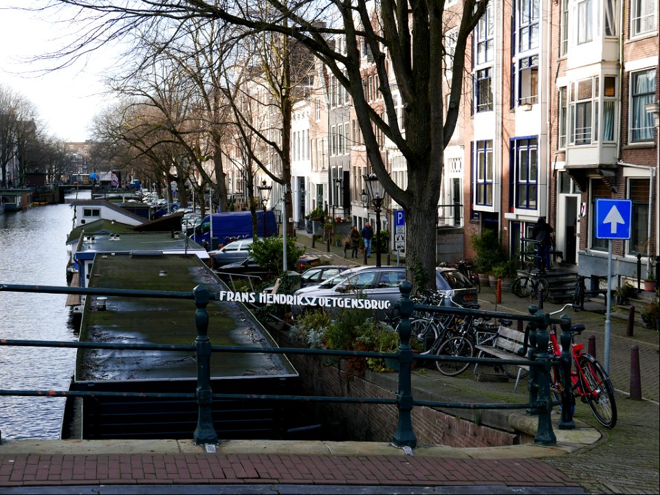 Old brick bridge over the canal Prinsegracht where the canal is crossing river Amstel - in Amsterdam city; free urban photo by Fons Heijnsbroek, 2022. photo