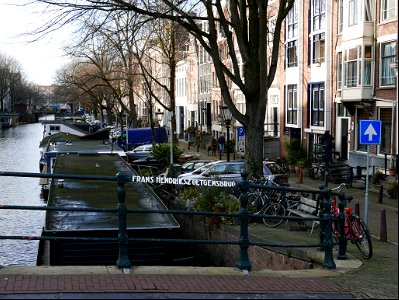 Old brick bridge over the canal Prinsegracht where the canal is crossing river Amstel - in Amsterdam city; free urban photo by Fons Heijnsbroek, 2022. photo