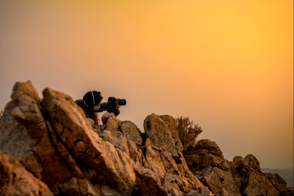 Photographer and smoke from Apple Fire at sunset at Eureka Peak