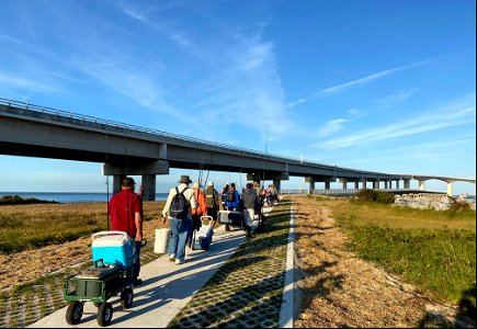 Anglers on their way to use the Bonner Bridge Pier for the first time