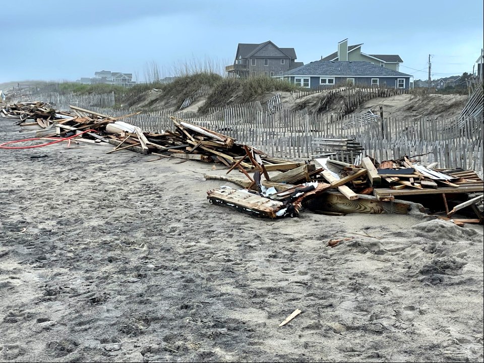 Piles of collected debris associated with collapsed houses
