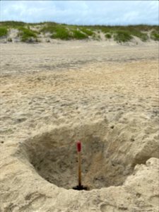 Large hole in beach photo