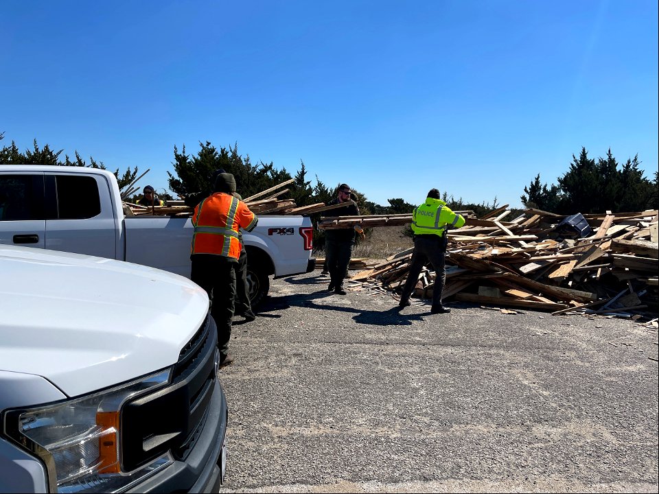 National Park Service employees transfer debris to staging pile photo