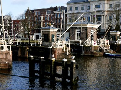 Close-up view of old water locks in the river Amstel , Amsterdam city; free urban photo by Fons Heijnsbroek, 2022. photo