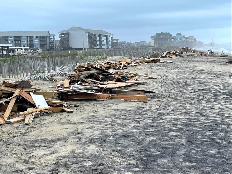 Piles of collected debris associated with collapsed houses photo