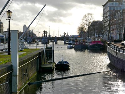 A river-view over the Amstel water, seen from the old locks in the city Amsterdam; free urban photo by Fons Heijnsbroek, 2022.