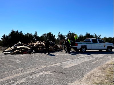 National Park Service employees work to transfer debris from truck to debris staging pile photo
