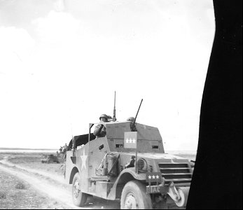 SC 171647 - Lt. Gen. George Patton, commander of II Army Corps, in half-track personally directing toward Gabes, Tunisia, and and south of [illegible], Tunisia. 30 March, 1943. photo