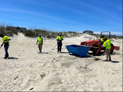 Contractors work to clean beach debris photo