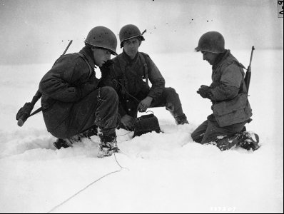 SC 337207 - Men of the HQ Battery, 102nd F.A., 26th Div., U.S. Third Army, check a forward line observation post on the outskirts of Wiltz. photo