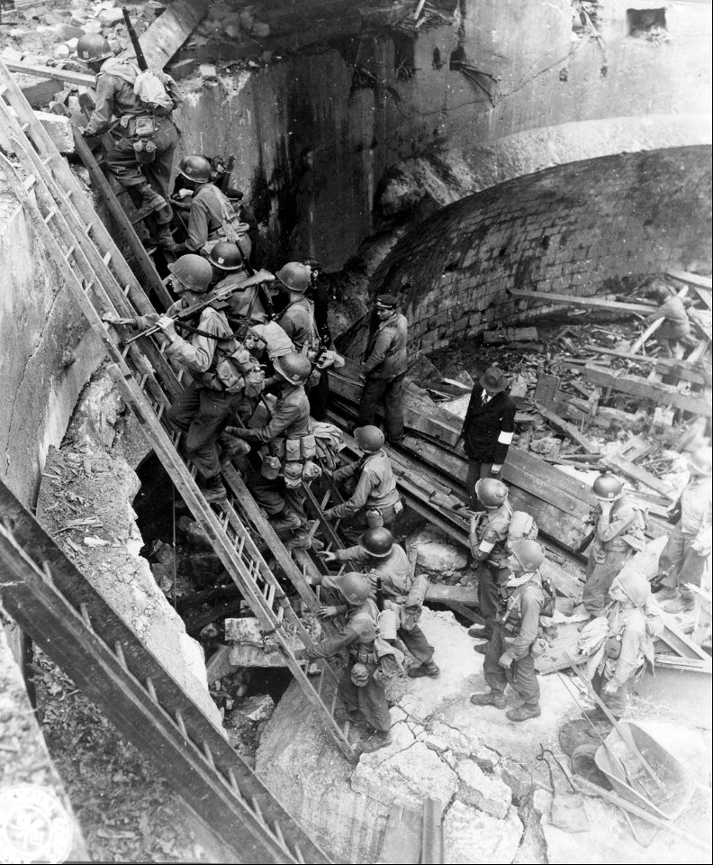 SC 270622 - Men climbing ladders to allow crossing of Doubs River in Besancon. 8 September, 1944.