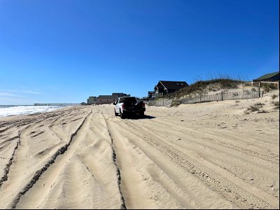 Truck travels along beach north of Rodanthe Pier photo