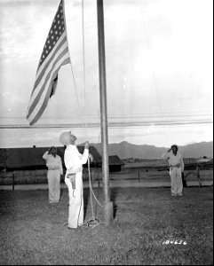 SC 184656 - "Old Glory" is lowered in a retreat ceremony somewhere in the South Pacific Area by Cpl. John O. Crittonden, a member of an Air Base Security Bn. 29 June, 1943.