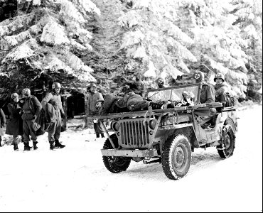 SC 199108 - Medics of the 84th Division bring casualties back on their jeep, near Samres, Belgium. 13 January, 1945. photo