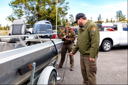 AIS technicians inspecting a motorized boat and trailer photo