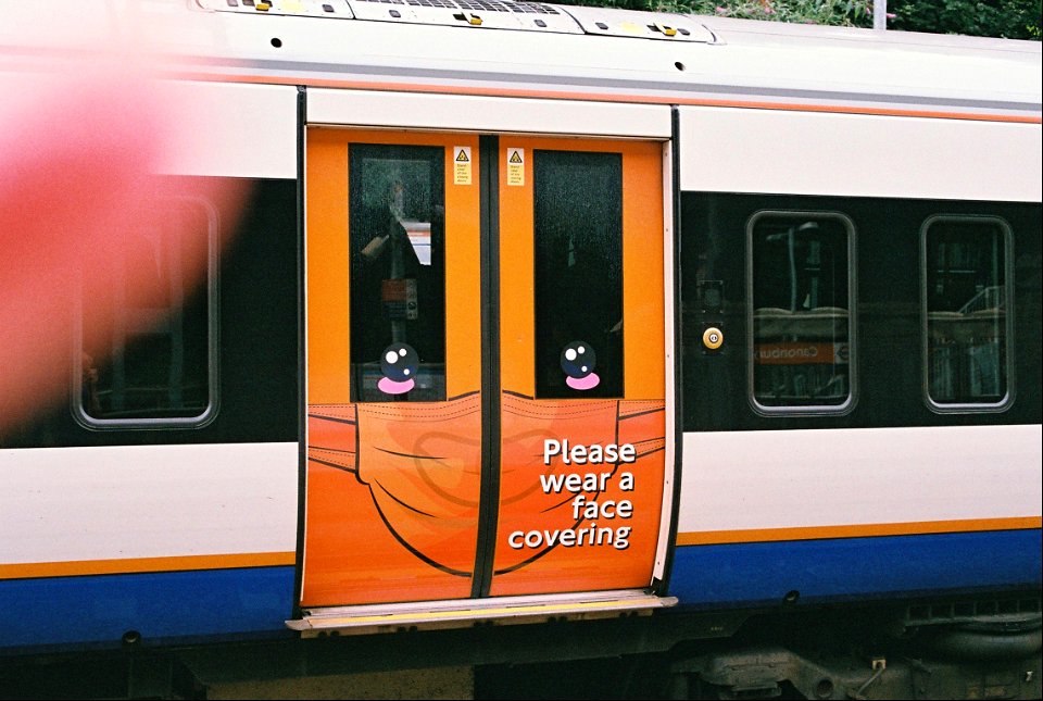 New face covering notice on doors of London Overground train