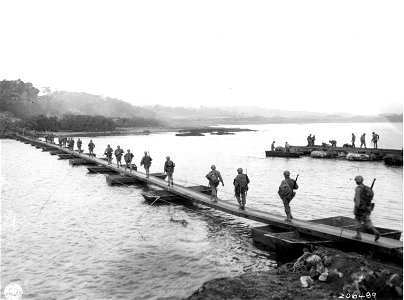 SC 206489 - Men of 27th Division, U.S. Tenth Army, cross ponton bridge on Okinawa to assault heavily fortified Jap position. photo