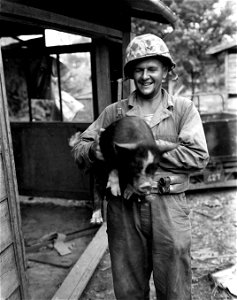 Combat correspondent Sgt. Charles R. Vandergriff, 24 Riddle Road, Cincinnati, Ohio, holding souvenir he "pigged" up. Saipan. June, 1944.