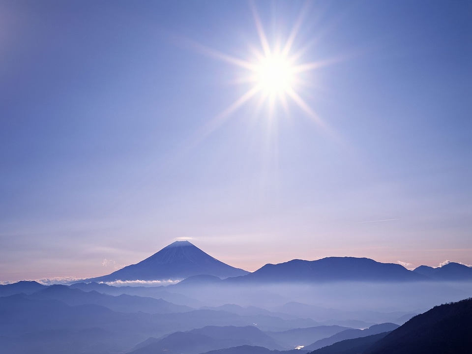 Sunny landscape in mountains and the dark sky
