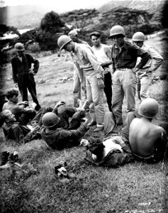 SC 151519 - Medical officers inspect mens' feet after a hard day's march during manuevers in Hawaii.