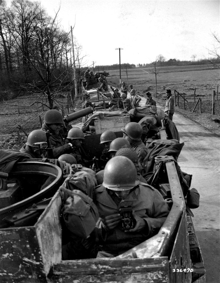 SC 336970 - Soldiers of the 8th Armored Division rest along the roadside, during the drive toward the Rhine River. U.S. Ninth Army. 2 March, 1945. photo