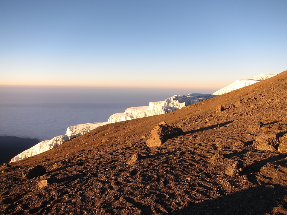 Kilimanjaro mountain Tanzania snow capped under cloudy blue skies