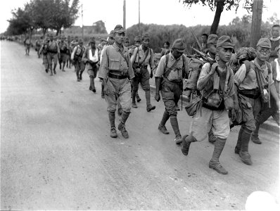 SC 221533 - Japanese soldiers are shown marching through Nanking's residential section. These soldiers are still fully armed but under perfect control at all times.