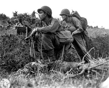 SC 270795 - With a mortar squad of the 32nd Regiment, 7th Div., on Okinawa are Pfc. Guillermo Acosta, Los Angeles, Cal., and Pfc. James Barnes, Pontiac, Mich., both of whom have also participated in the assaults on Attu, Kwajalein, and Leyte. photo