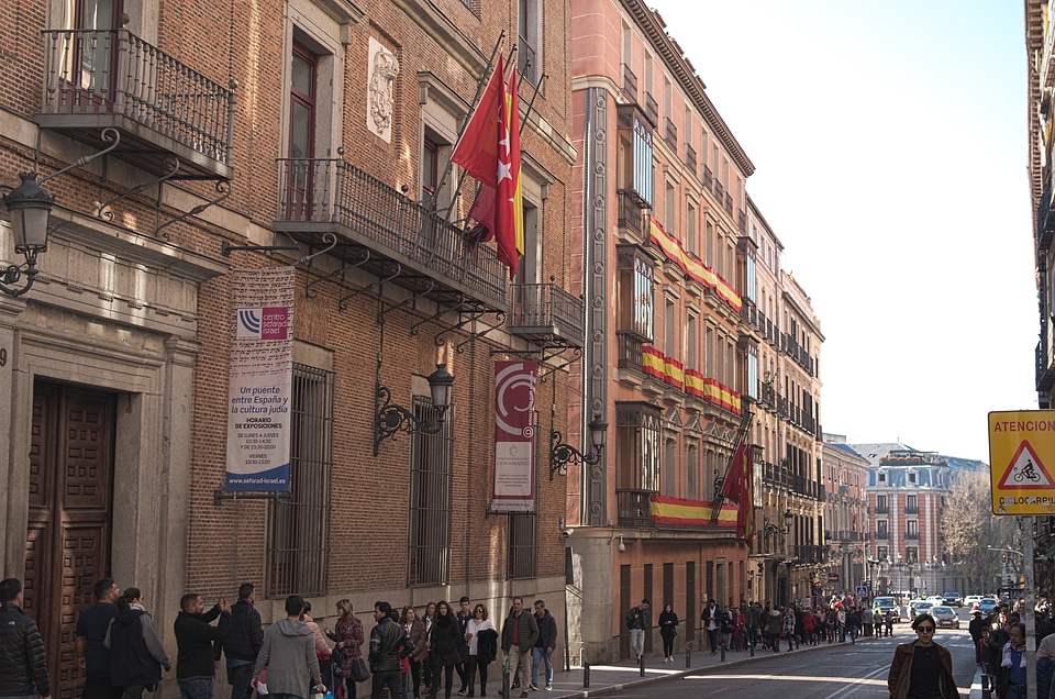 Main Street of Madrid adorned with flags of Spain